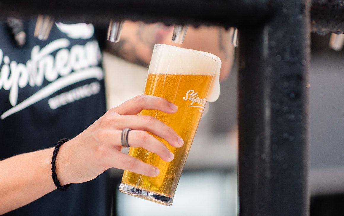 a beer being poured from a tap